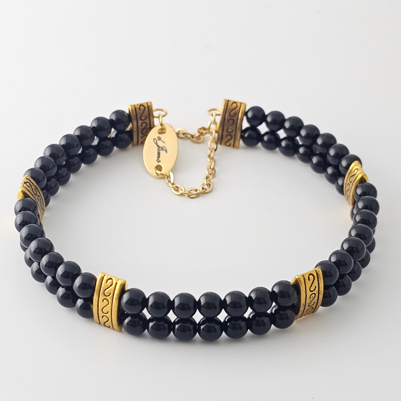 Black Onyx 4mm Double Strand Bracelet featuring sleek black beads on silver-plated memory wire with a fixed safety chain.