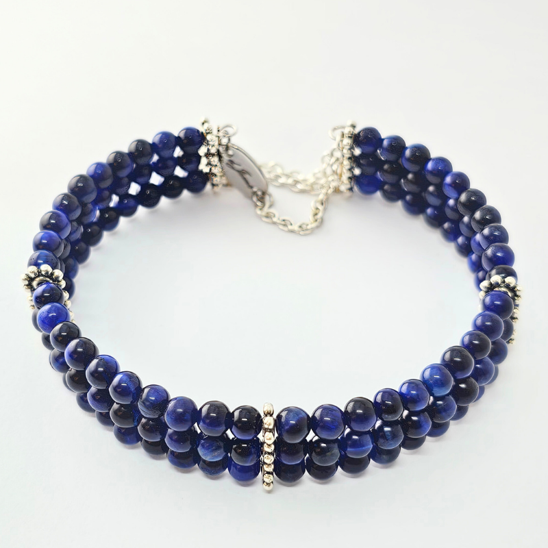 Blue Tiger's Eye 4mm Triple Strand Bracelet featuring deep blue chatoyant beads on silver-plated memory wire.