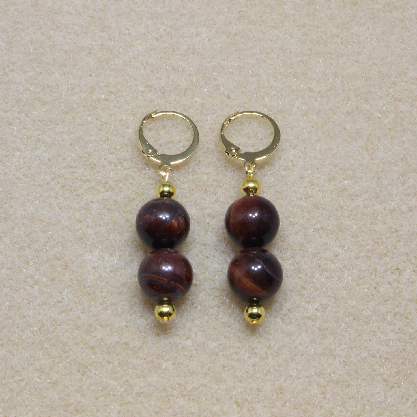 Red Tiger's Eye Drop Earrings with 10mm beads and lever-back closures, showcasing the stone's rich reddish-brown hue.