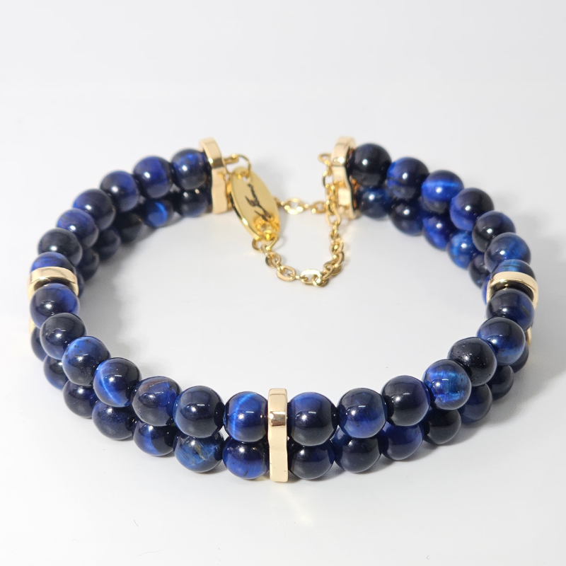 Elegant Blue Tiger’s Eye 6mm double strand bracelet featuring polished deep blue beads, gold accent spacers, and a gold clasp with adjustable chain.
