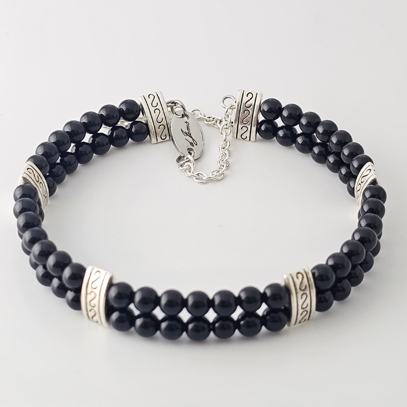 Black Onyx 4mm Double Strand Bracelet featuring sleek black beads on silver-plated memory wire with a fixed safety chain.
