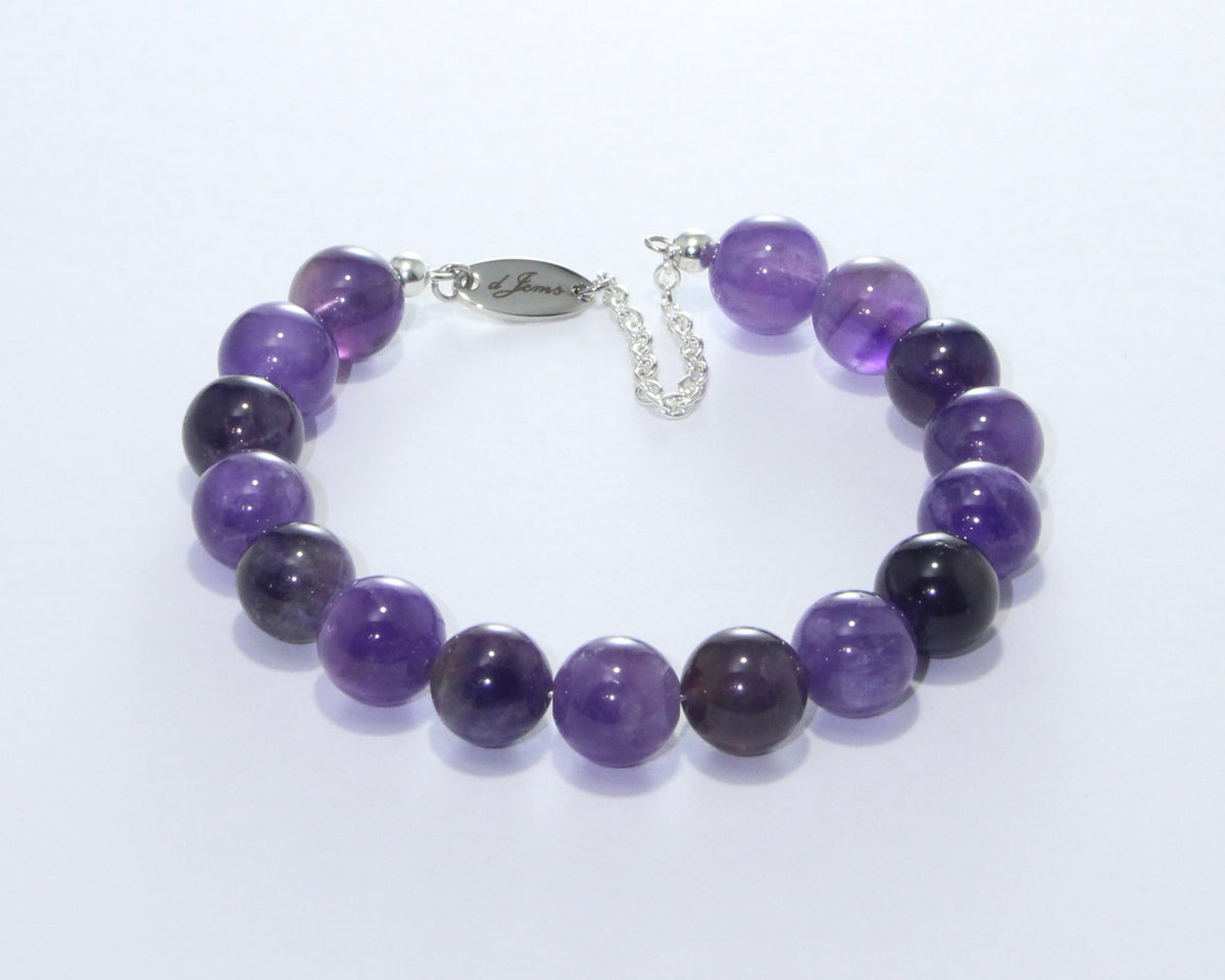 A handmade bracelet with 10mm violet quartz beads and a gold-colored clasp, displayed against a white background.