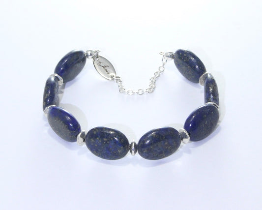 Handmade Lapis Lazuli Oval Bracelet featuring 16x12mm deep blue lapis lazuli beads with elegant spacers on plated stainless steel memory wire with a fixed safety chain.