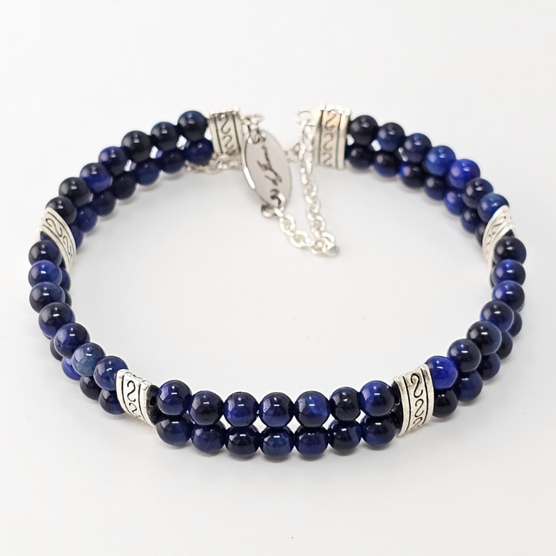 Blue Tiger's Eye 4mm Double Strand Bracelet featuring deep blue beads with natural chatoyancy on silver-plated memory wire, secured with a fixed safety chain.