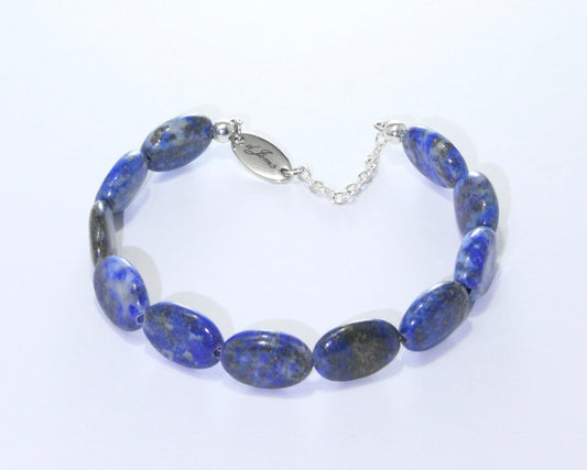 Handmade Lapis Lazuli Oval Bracelet showcasing 12x10mm deep blue lapis lazuli beads on plated stainless steel memory wire with a fixed safety chain.
