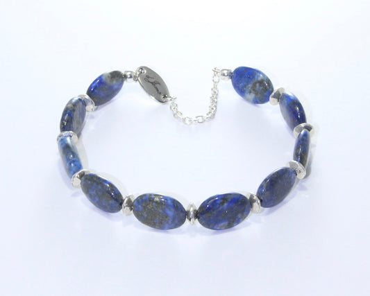 Close-up of Lapis Lazuli Oval Bracelet showing 5mm deep blue oval beads with silver spacers, highlighting the stone's natural patterns.