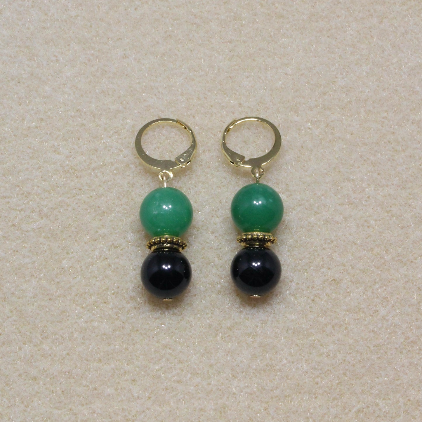 Pair of Tourmaline & Aventurine Drop Earrings showcasing 10mm black and green stones with lever-back closures, highlighting the unique patterns of the gemstones.