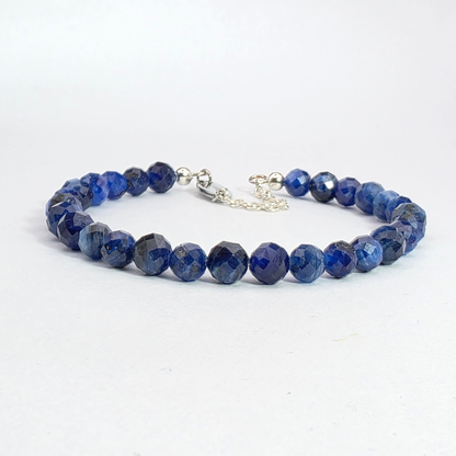 Blue beaded bracelet on a white background