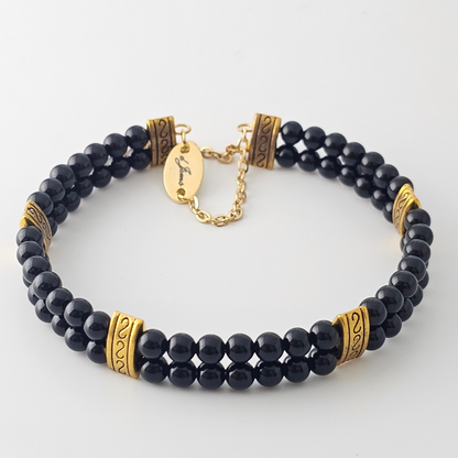 Black Onyx 4mm Double Strand Bracelet featuring sleek black beads on silver-plated memory wire with a fixed safety chain.