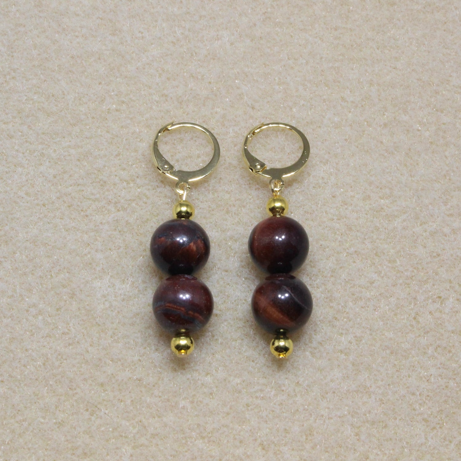 Red Tiger's Eye Drop Earrings with 10mm beads and lever-back closures, showcasing the stone's rich reddish-brown hue.