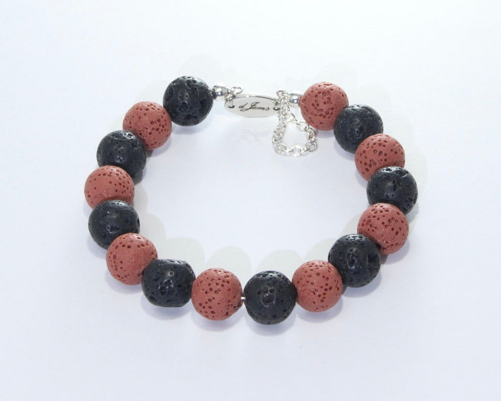 Handmade Black Lava Rock Bracelet showcasing 10mm natural lava rock beads on plated stainless steel memory wire with a fixed safety chain.

