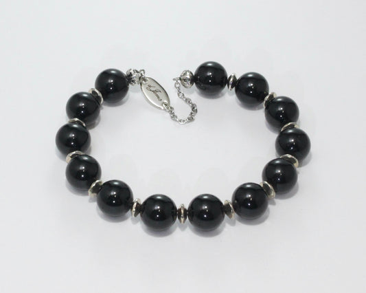Handmade Black Tourmaline Bracelet showcasing 10mm deep black tourmaline beads with elegant spacers on plated stainless steel memory wire with a fixed safety chain.