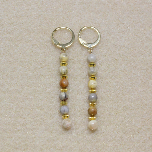 Handmade Crazy Lace Agate Dangle Earrings featuring natural gemstone swirls in red, brown, and cream hues on gold-tone lever-back hooks.