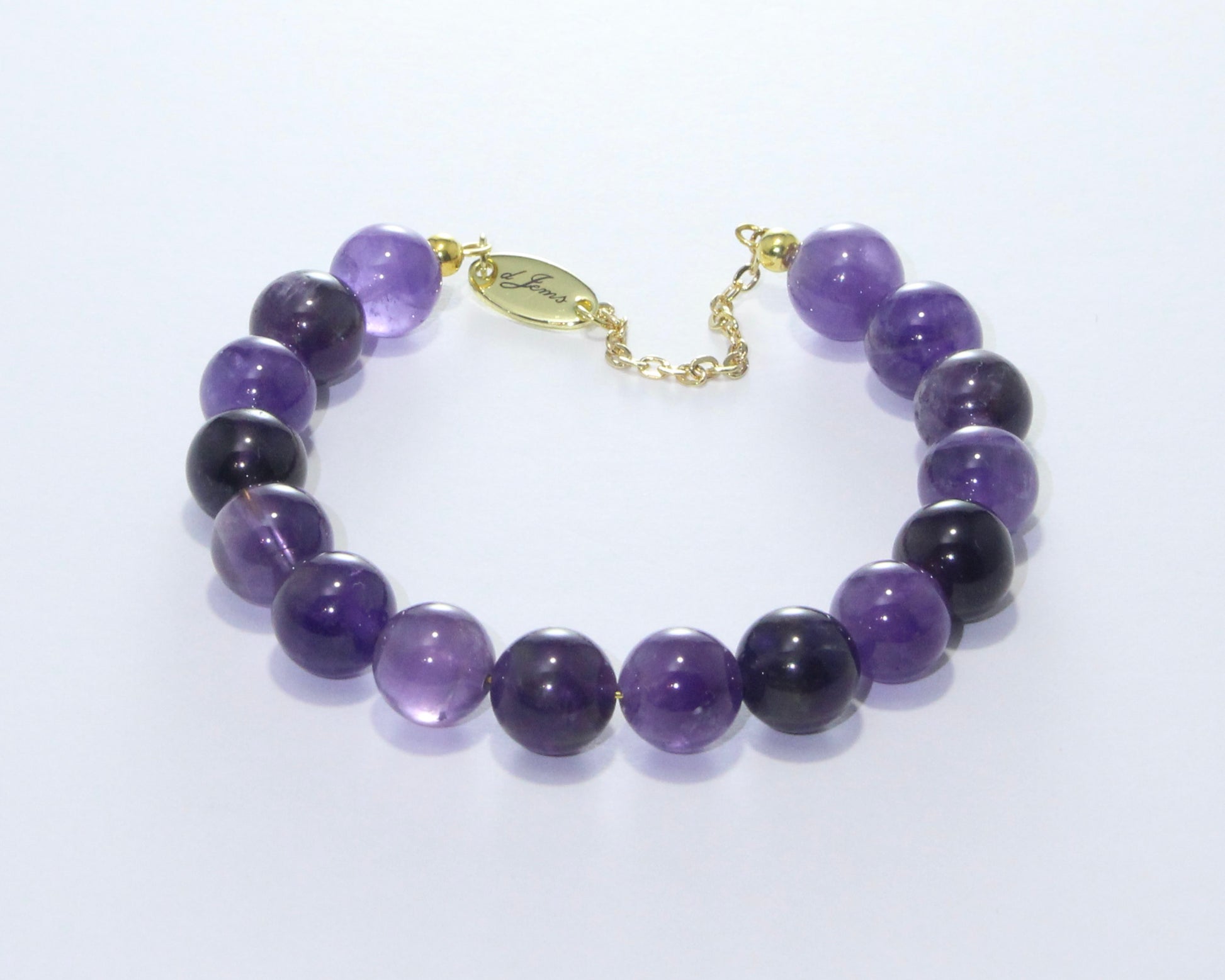Handmade Amethyst Bracelet showcasing 10mm violet quartz beads on plated stainless steel memory wire with a fixed safety chain.