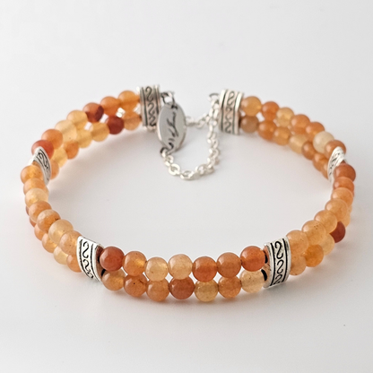 Red Aventurine 4mm Double Strand Bracelet featuring smooth red beads on silver-plated memory wire with a fixed safety chain.