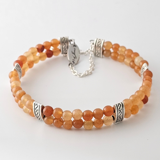 Red Aventurine 4mm Double Strand Bracelet featuring smooth red beads on silver-plated memory wire with a fixed safety chain.