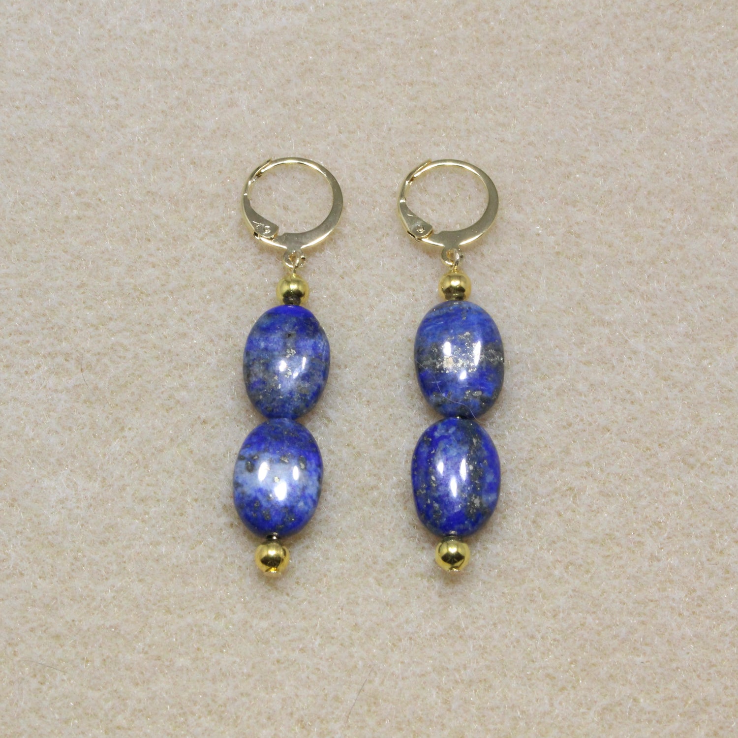 Pair of Lapis Lazuli Drop Earrings showcasing natural deep blue stones with lever-back closures, highlighting the stone's rich color and smooth texture.