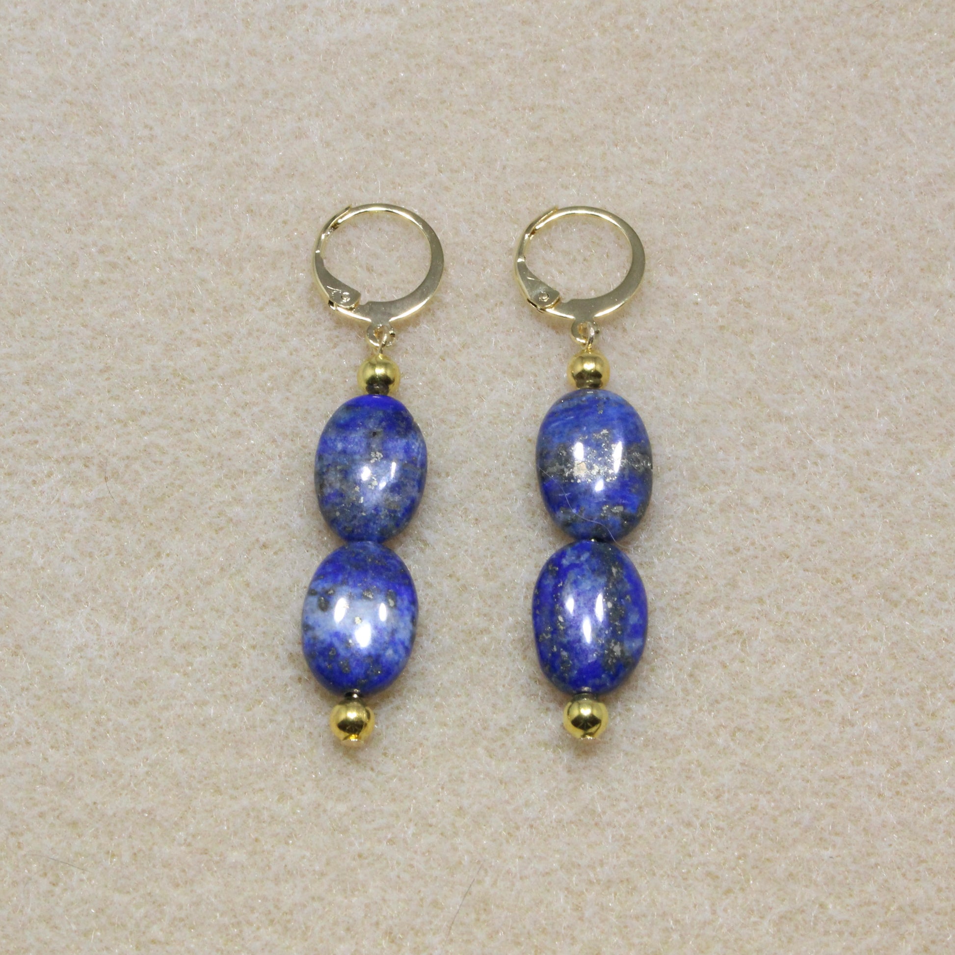 Pair of Lapis Lazuli Drop Earrings showcasing natural deep blue stones with lever-back closures, highlighting the stone's rich color and smooth texture.