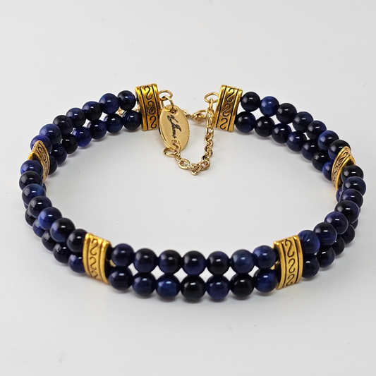 Blue Tiger's Eye 4mm Double Strand Bracelet featuring deep blue beads with natural chatoyancy on silver-plated memory wire, secured with a fixed safety chain.
