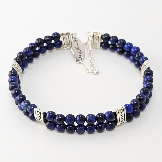 Blue Tiger's Eye 4mm Double Strand Bracelet featuring deep blue beads with natural chatoyancy on silver-plated memory wire, secured with a fixed safety chain.