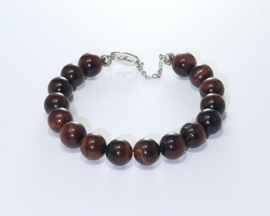 Handmade Red Tiger's Eye Bracelet showcasing 10mm deep reddish-brown chatoyant beads on plated stainless steel memory wire with a fixed safety chain.