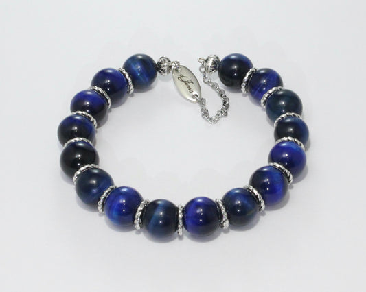 Handmade Blue Tiger's Eye Bracelet showcasing 10mm deep blue beads with elegant spacers on plated stainless steel memory wire with a fixed safety chain.