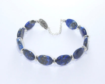 Close-up of Lapis Lazuli Oval Bracelet showing 5mm deep blue oval beads with silver spacers, highlighting the stone's natural patterns.
