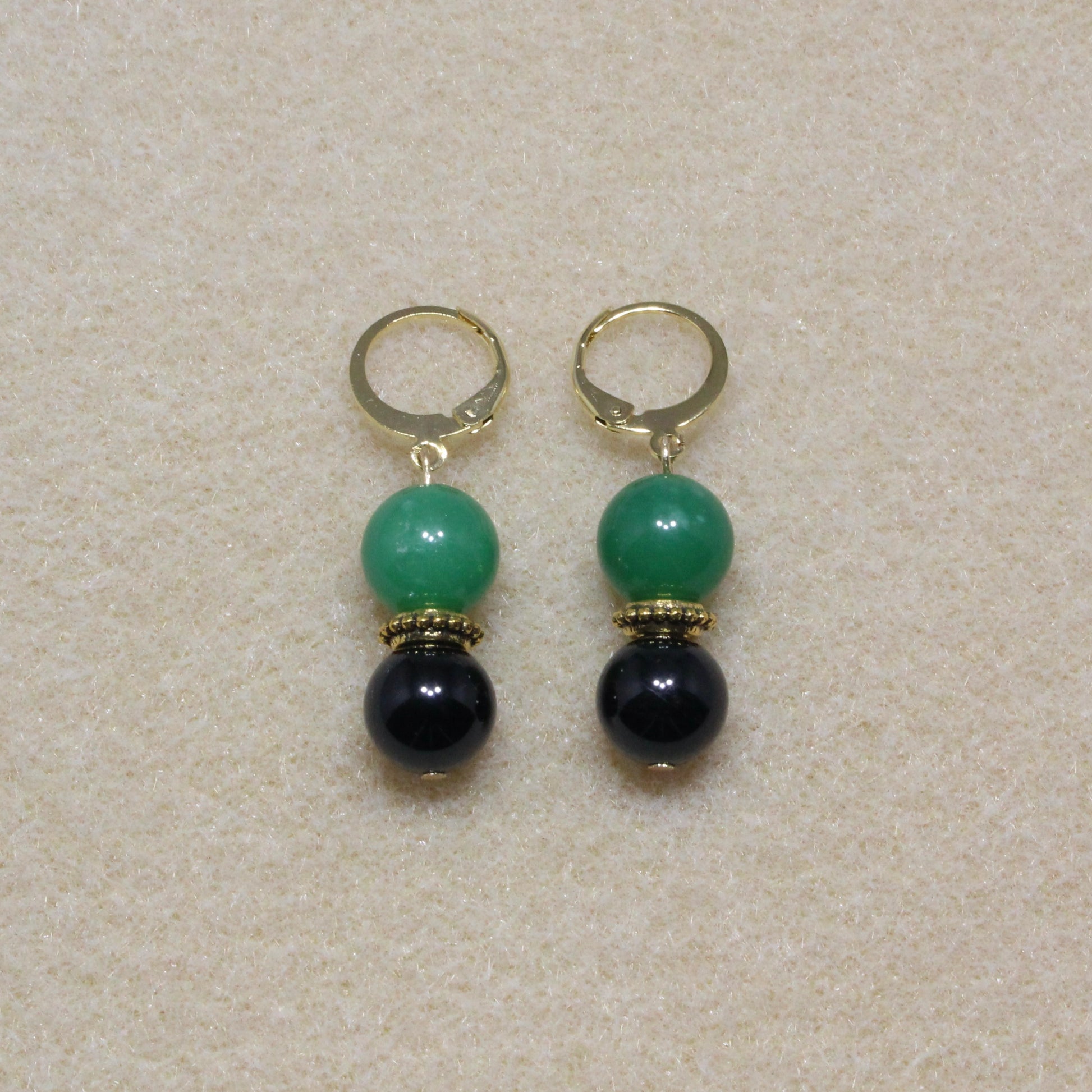 Pair of Tourmaline & Aventurine Drop Earrings showcasing 10mm black and green stones with lever-back closures, highlighting the unique patterns of the gemstones.