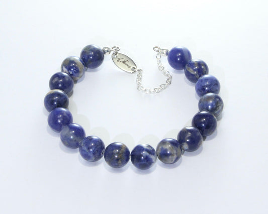 Handmade Sodalite Bracelet featuring 10mm royal blue sodalite beads with creamy white veins on plated stainless steel memory wire with a fixed safety chain.