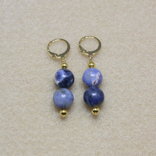 Pair of Sodalite Drop Earrings showcasing 8mm natural blue stones with lever-back closures, highlighting the stone's unique patterns.
