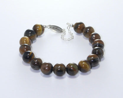 Handmade Brown Tiger's Eye Bracelet showcasing 8mm or 10mm golden-brown beads with chatoyant patterns on plated stainless steel memory wire with a fixed safety chain.