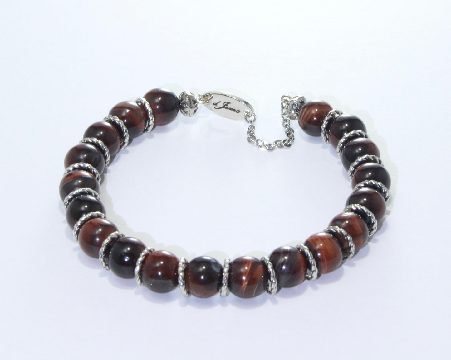 Handmade Red Tiger's Eye Bracelet showcasing 10mm deep red beads on plated stainless steel memory wire with a fixed safety chain.

