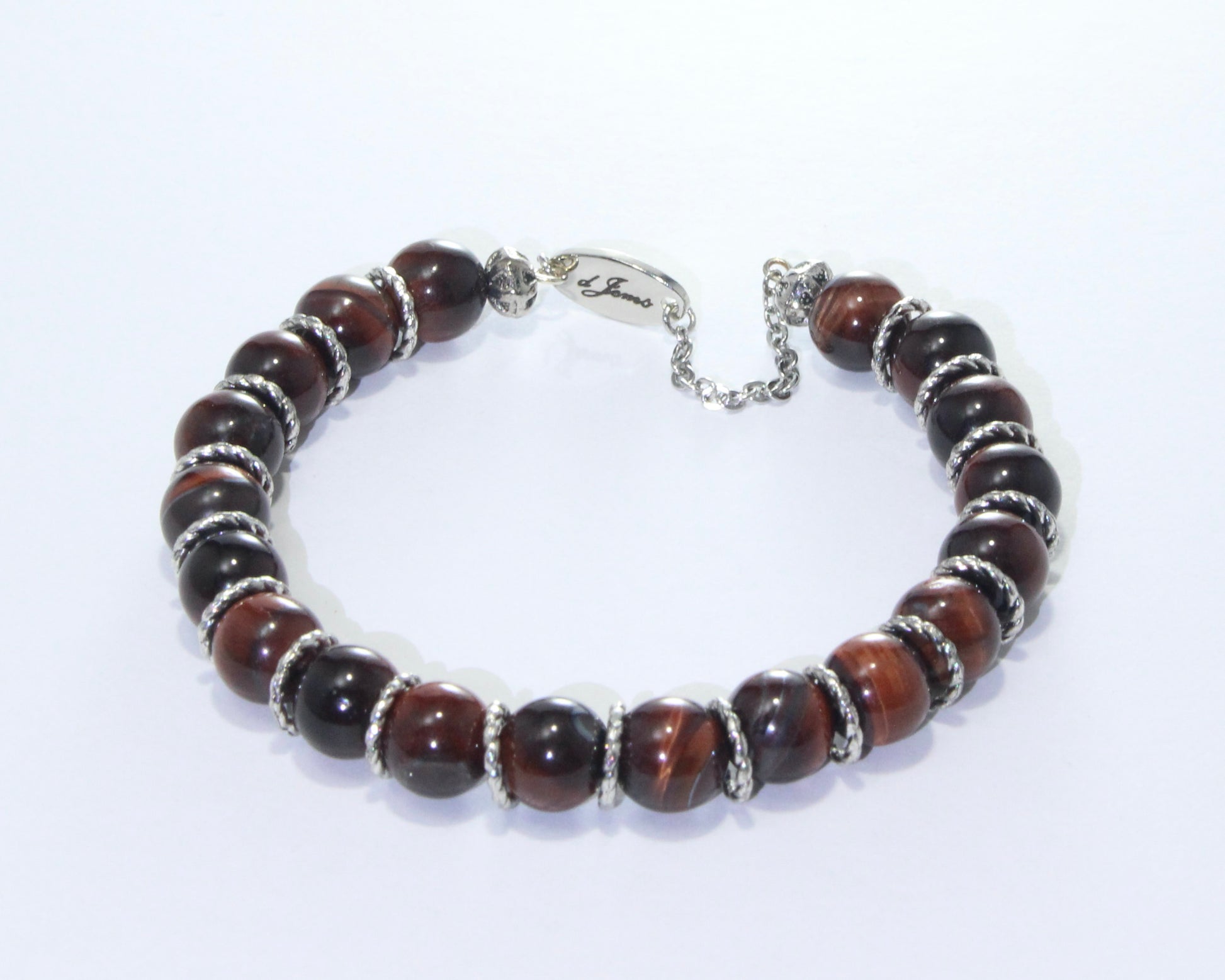 Handmade Red Tiger's Eye Bracelet showcasing 10mm deep red beads on plated stainless steel memory wire with a fixed safety chain.

