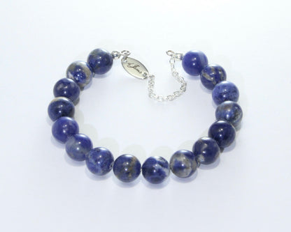 Close-up image of the Sodalite Bracelet showcasing deep blue sodalite beads with natural white veins, strung on an elastic band.